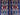 Close-up of bold tribal pattern on blue and red handmade Oriental rug