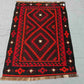 Tribal pattern 5x8 Kilim rug on wooden floor – vintage handmade Turkish wool flatweave.