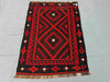 Tribal pattern 5x8 Kilim rug on wooden floor – vintage handmade Turkish wool flatweave.