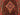 Close-up of geometric motifs on handmade red and black tribal wool rug

