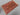 Top view of red tribal Afghan rug on wooden floor