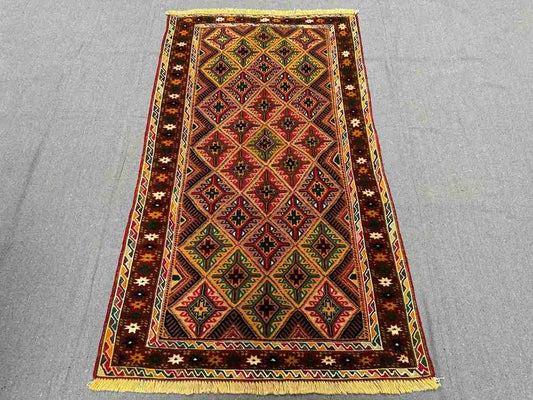 Floor view of tribal Afghan kilim runner rug placed in narrow space