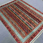 Handwoven wool Turkish area rug styled in bohemian home interior