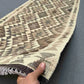 Handmade Turkish Kilim runner rug in hands – showcasing front wool texture in neutral tones.