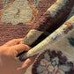 Handmade Turkish Oushak Rug 5x7 ft shown in hands – hand-knotted beige and brown wool carpet