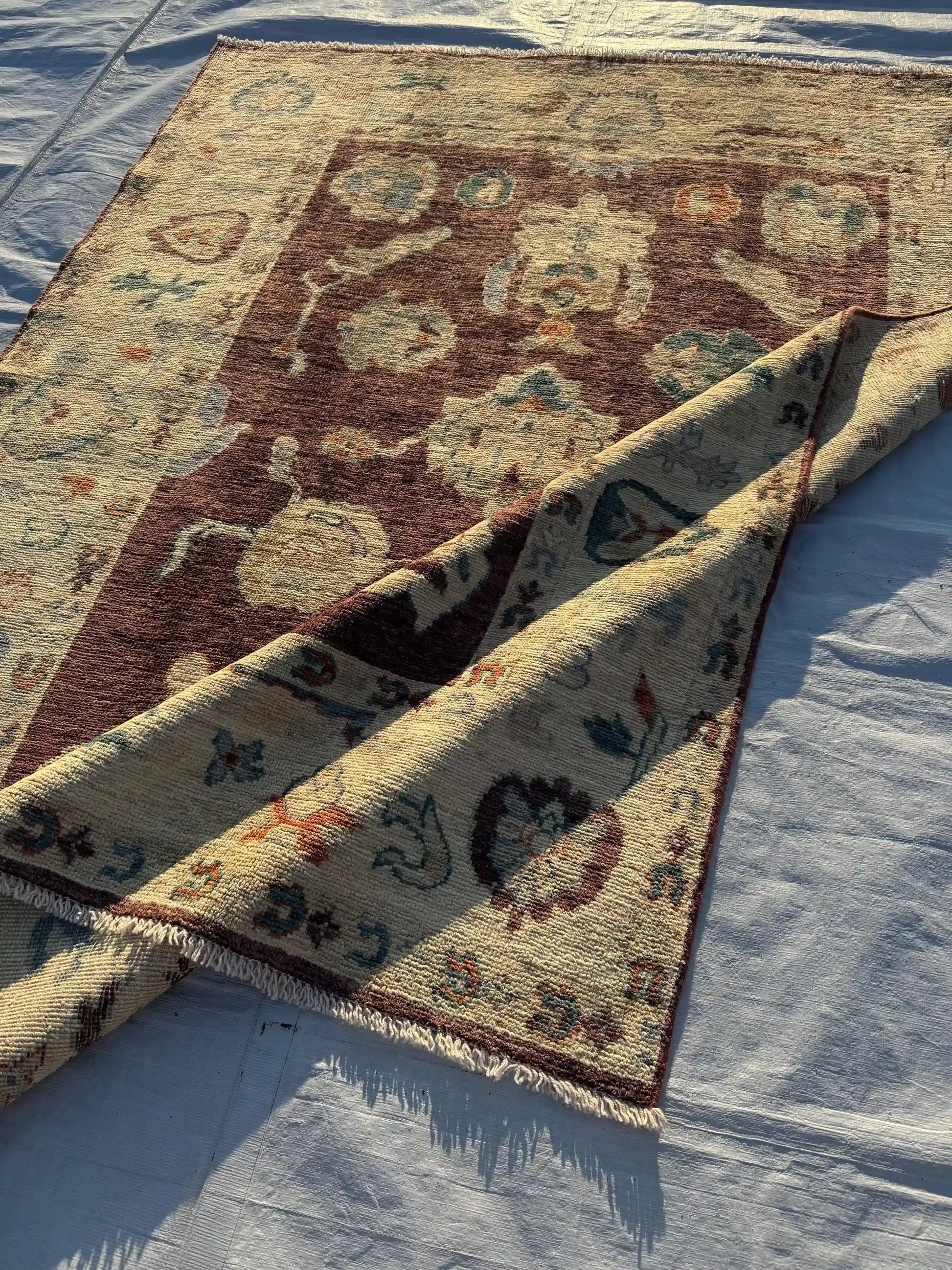 Folding display of Turkish wool Oushak rug with oriental design
