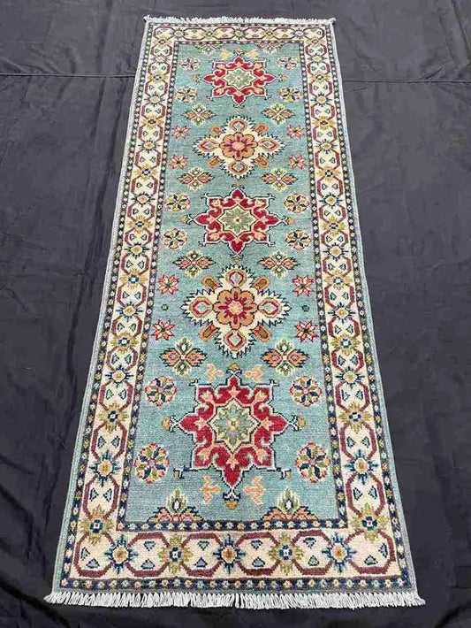 Hand-knotted wool runner rug on floor – hallway or living space decor.