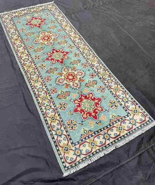 Side view of Turkish runner rug laid on hallway floor.