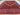 Turkmen Mushwani wool rug 6'7''x9' styled in living room – red and navy geometric design