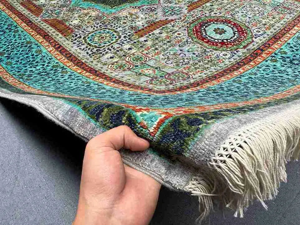 Handmade turquoise and green Mamluk rug in hands – 5x8 wool and silk Oriental carpet