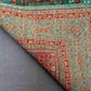 Folded vibrant Mamluk carpet showing fine wool weave and rich tones