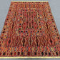 Vintage tribal kilim rug on wooden floor in living room setup