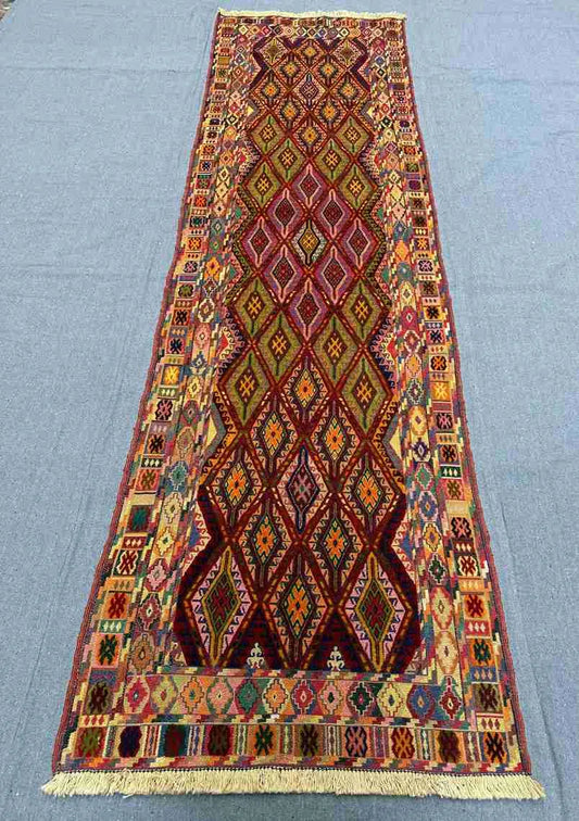 Turkish handmade kilim runner rug on hallway floor with tribal design