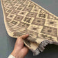 Handmade vintage Kilim runner rug held in hands – front view
