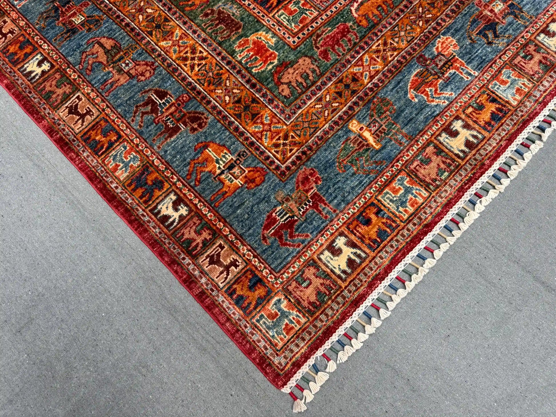 Corner view of vintage Pazyryk rug on wooden floor