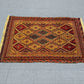 Vintage red and gold kilim rug in home floor layout