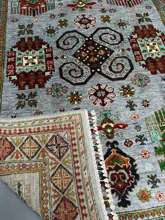 Side fold of 6x9 handmade Waziri tribal wool carpet