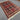 5x7 handmade wool rug styled in a cozy bedroom setup