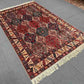 5x7 handmade wool rug styled in a cozy bedroom setup