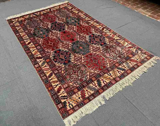 5x7 handmade wool rug styled in a cozy bedroom setup