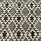 Close-up of wool flatweave Kilim rug texture – handmade and knotted in beige and brown tones.