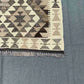 Close-up of corner detail on wool Kilim runner – vintage-inspired geometric pattern.