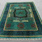 Interior styling with handwoven wool Mamluk rug in gold and teal