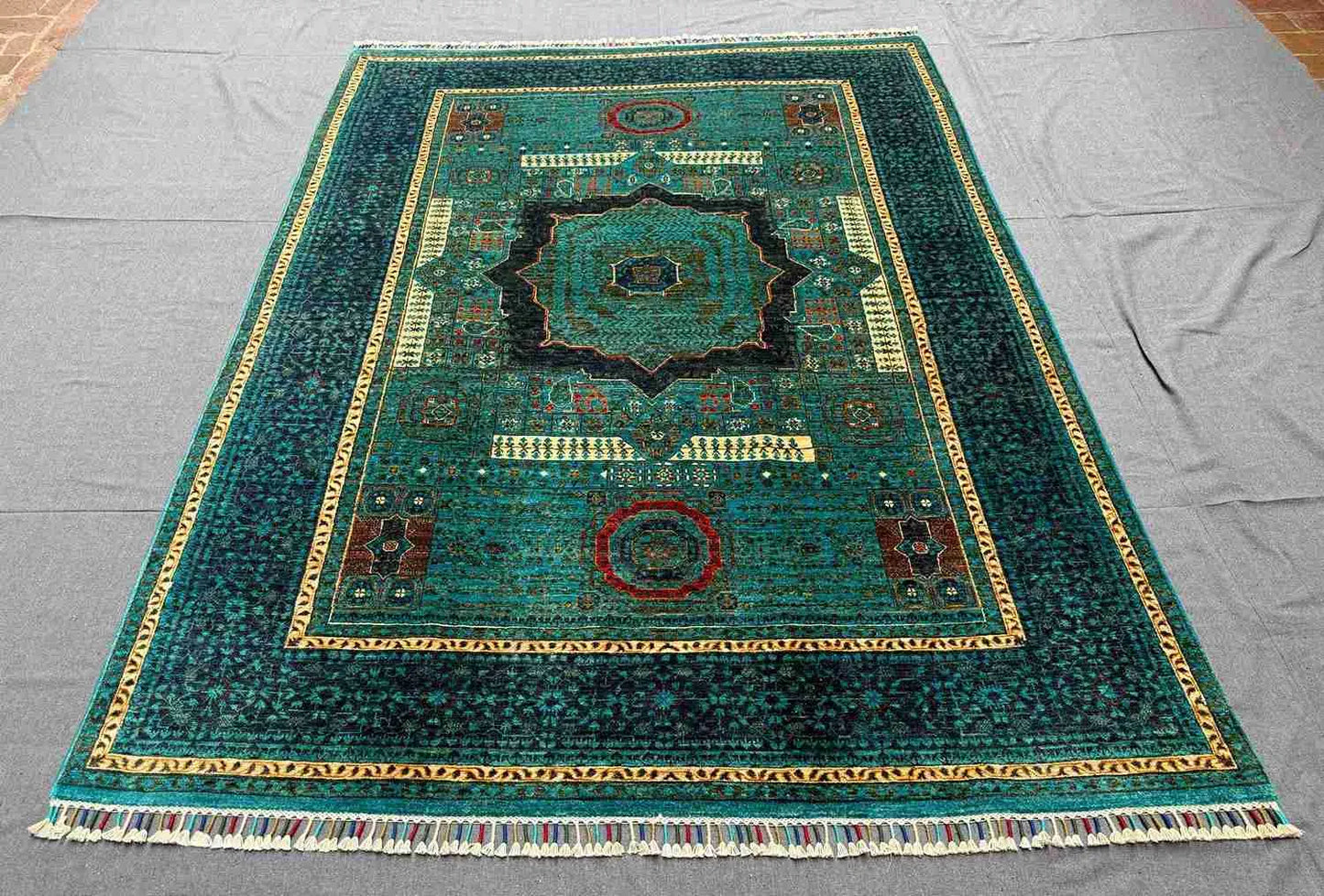 Interior styling with handwoven wool Mamluk rug in gold and teal
