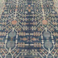 Close-up of Tree of Life pattern on blue and beige handmade wool rug