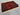 Folded display of red and black tribal wool rug
