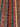 Close-up of woven wool texture – red, gold, blue, black striped tribal shawl