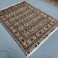 Wool silk handmade floral rug styled in modern bedroom setup