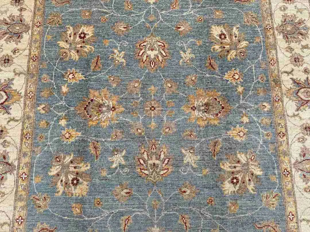Close-up of floral motif on Afghan Ziegler Chobi 5x7 wool rug