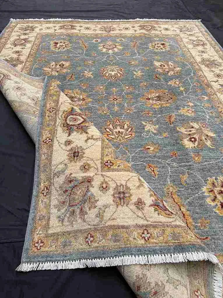 Folded view of hand-knotted Afghan Ziegler Chobi wool rug