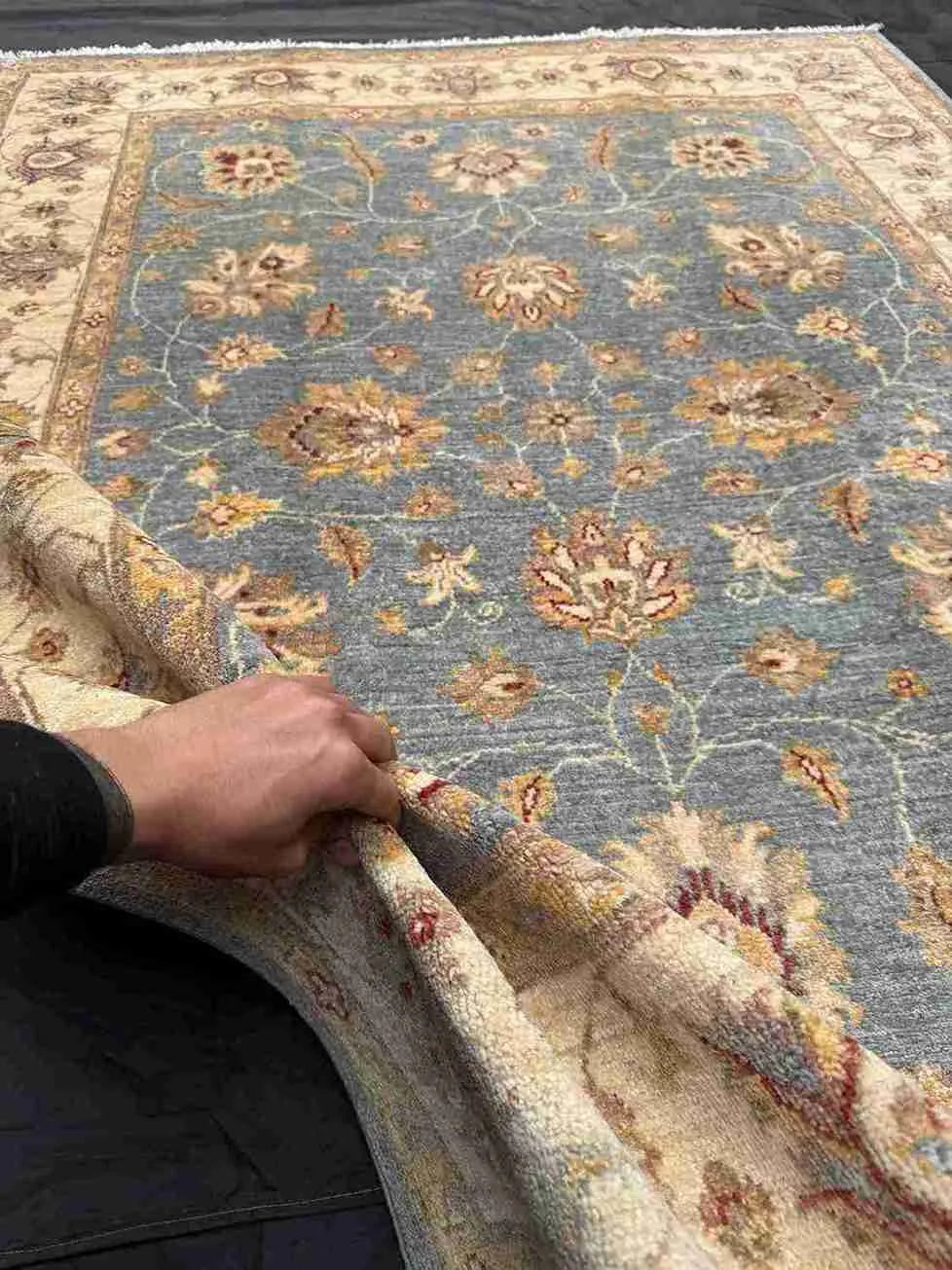 Handmade Afghan Ziegler Chobi Rug 5x7 ft shown in hands for scale