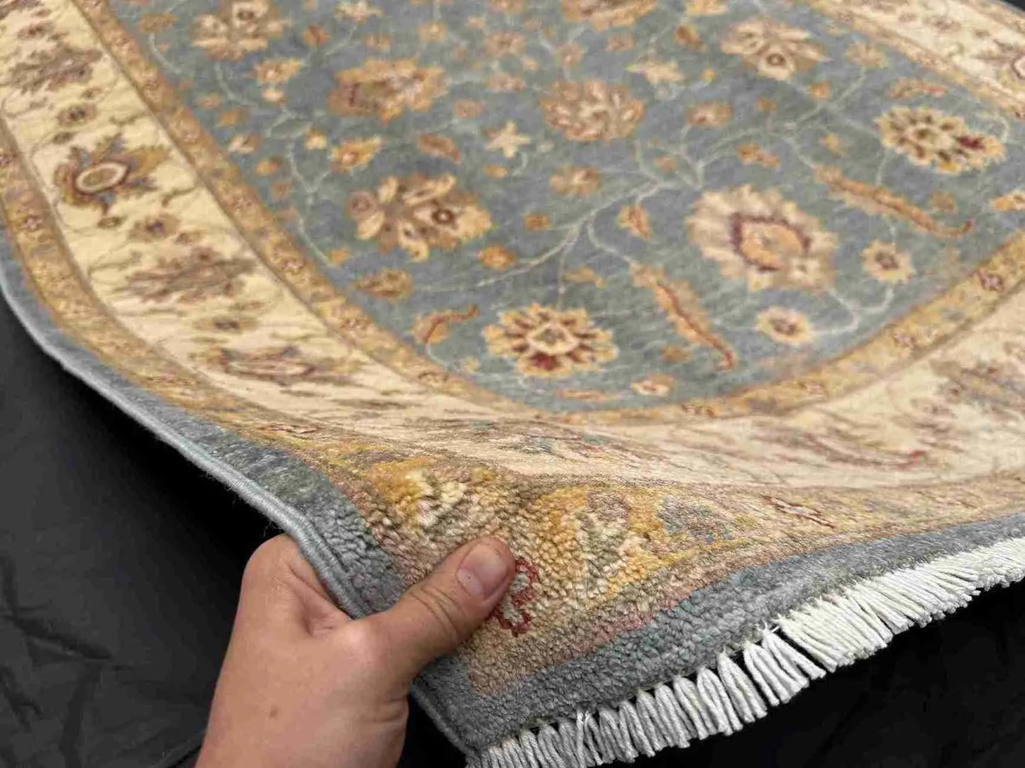 Person holding Authentic Ziegler Chobi Rug 5x7 ft – Blue Afghan wool carpet
